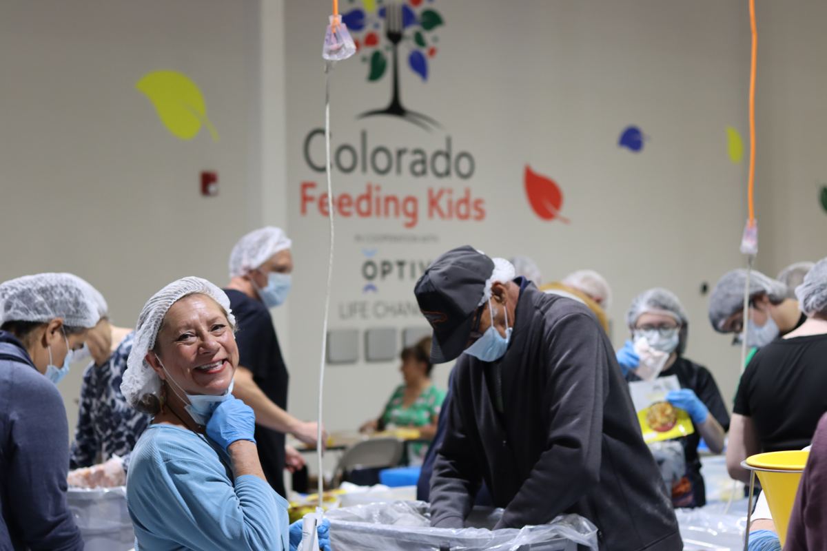 Volunteer smiling during a Colorado Feeding Kids packing event