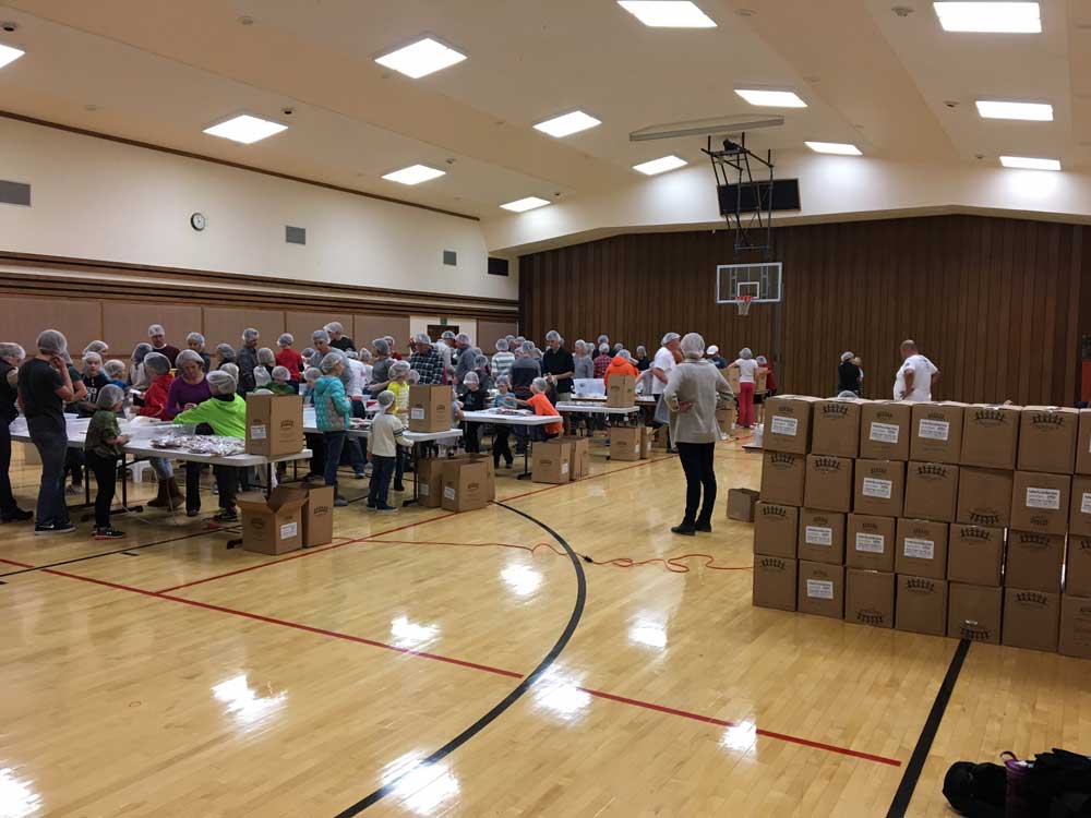 Volunteers packing meal packs at a Colorado Feeding Kids event
